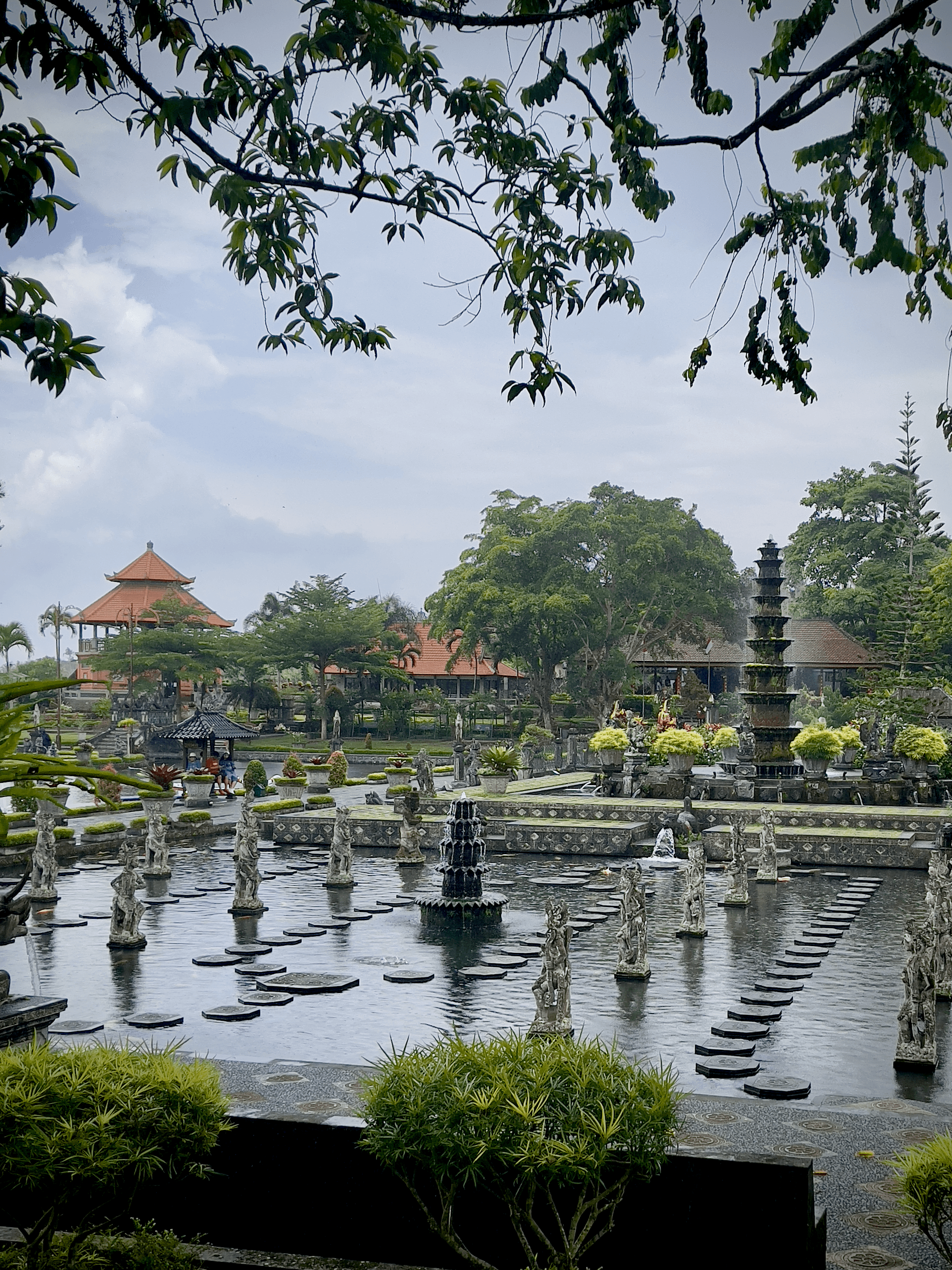 Tirta Gangga water palace in Bali, Indonesia with statues and water