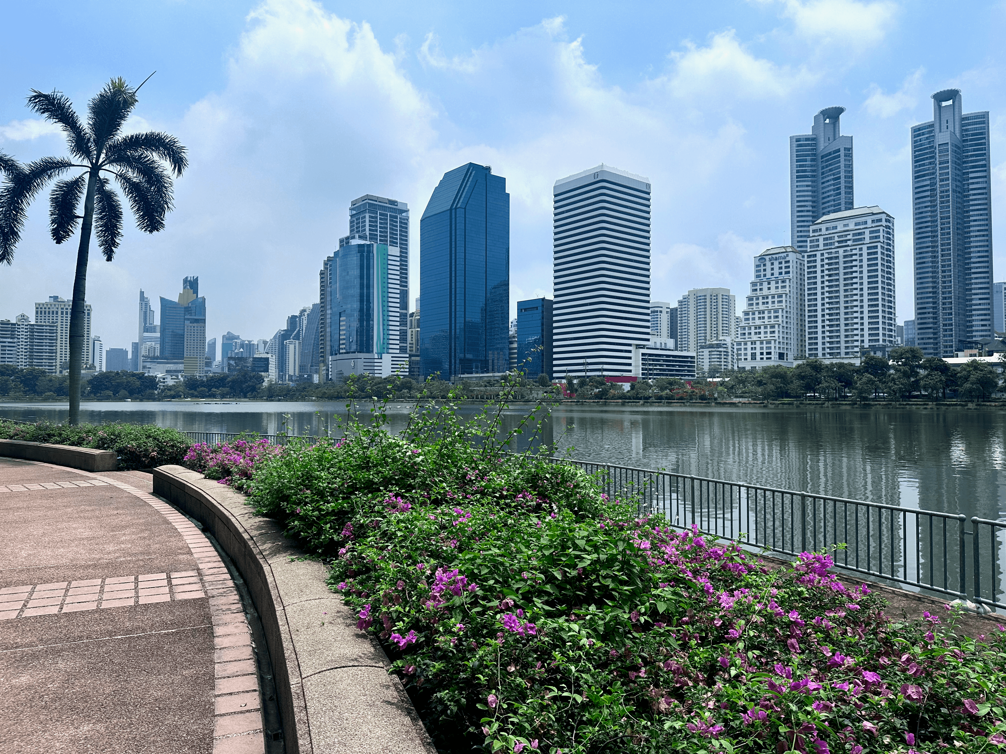City skyline and lake at Benjakitti Park in Bangkok, Thailand
