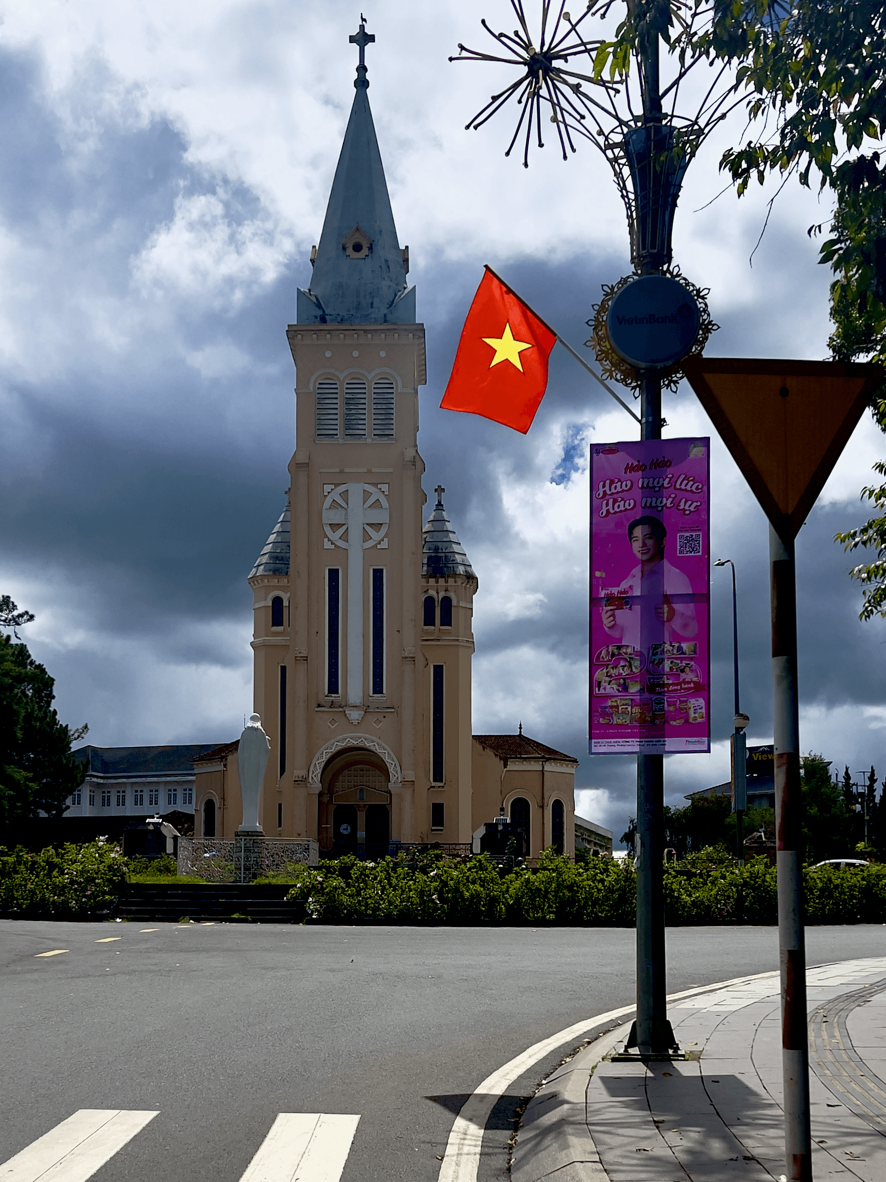 Da Lat Cathedral with Vietnamese flag and blue sky