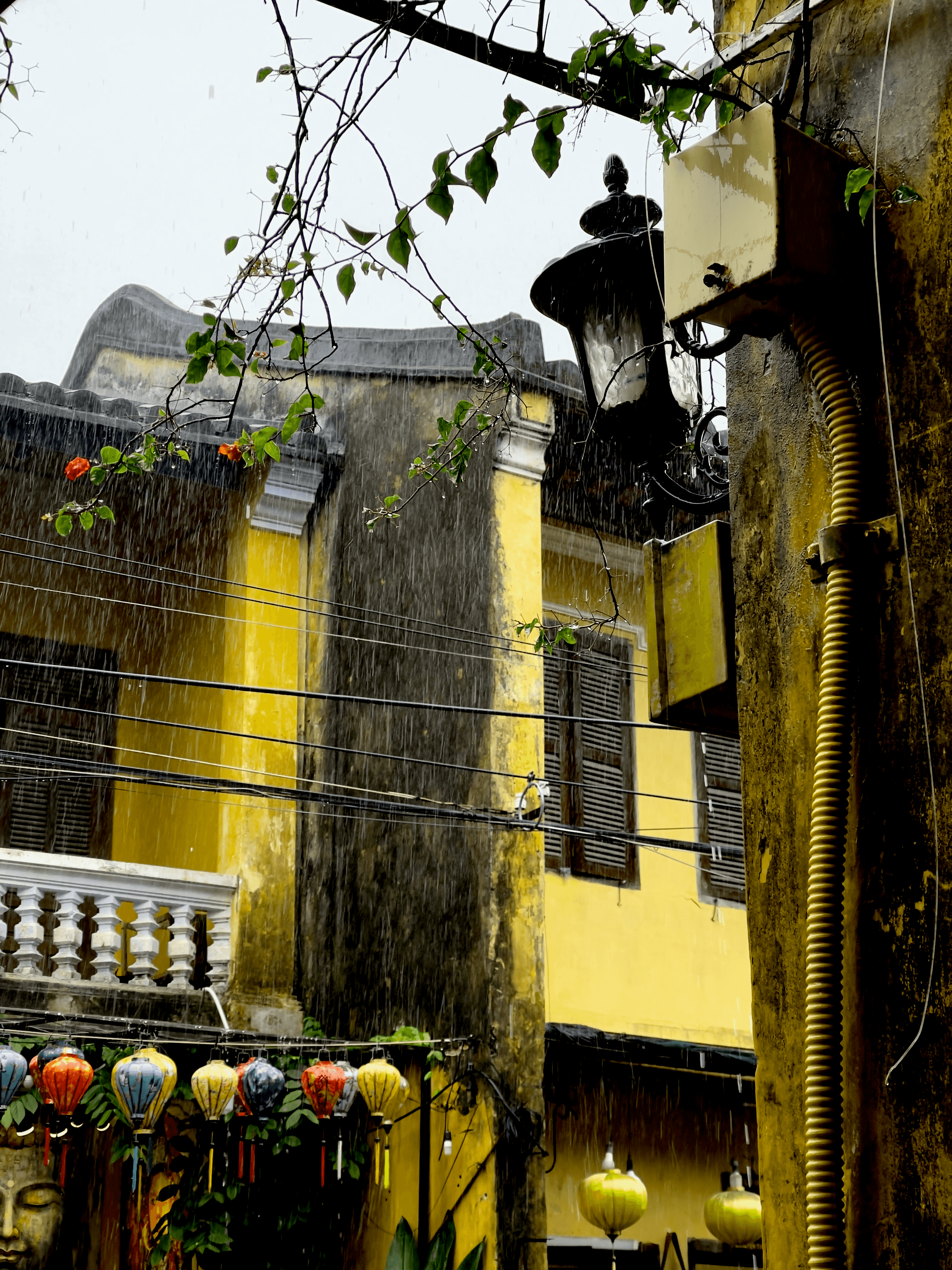 Rainy scene in the Hoi An Ancient Town in Vietnam with storefronts and lanterns