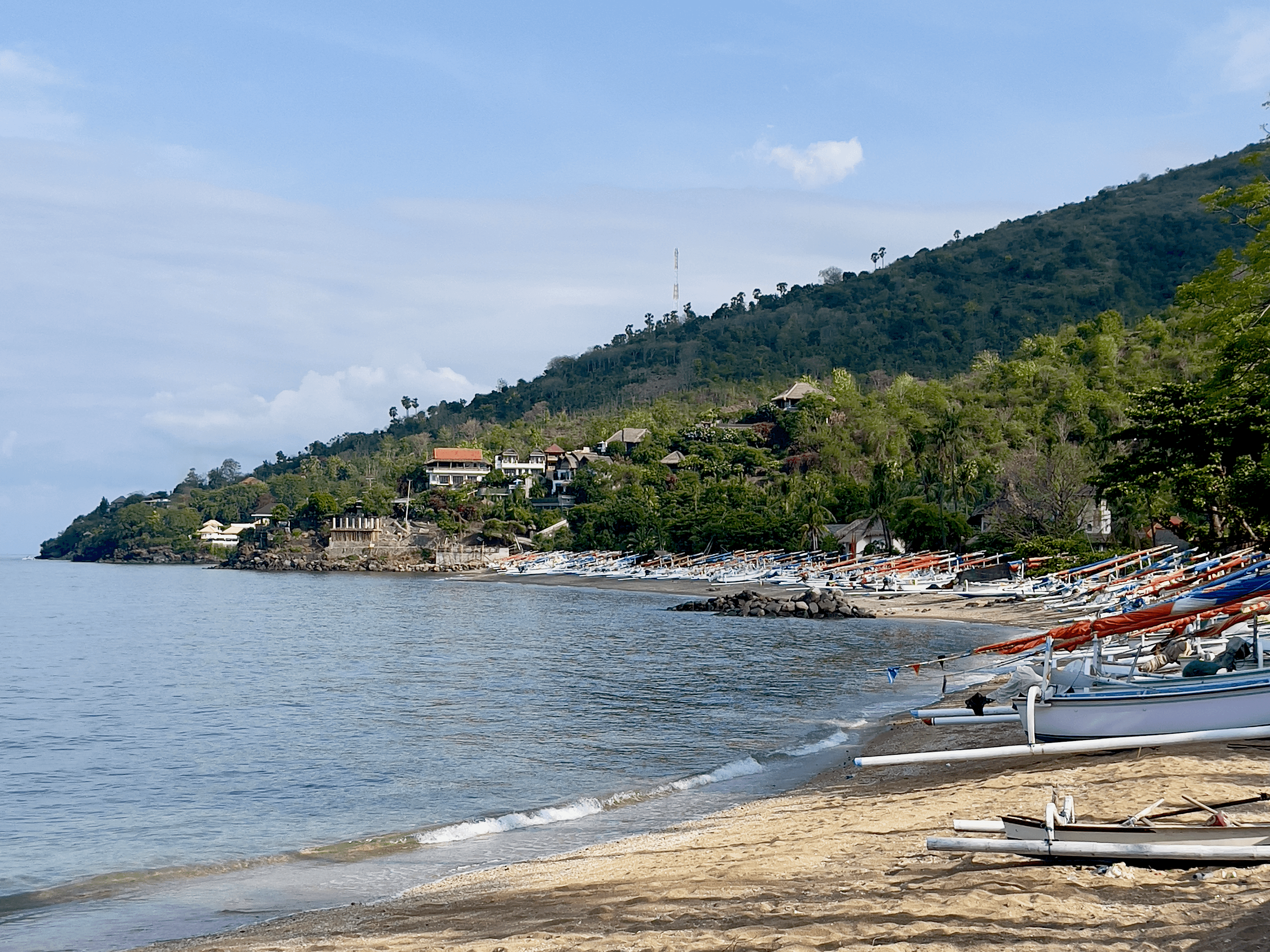 Boats on shore with view of the ocean in Bali, Indonesia