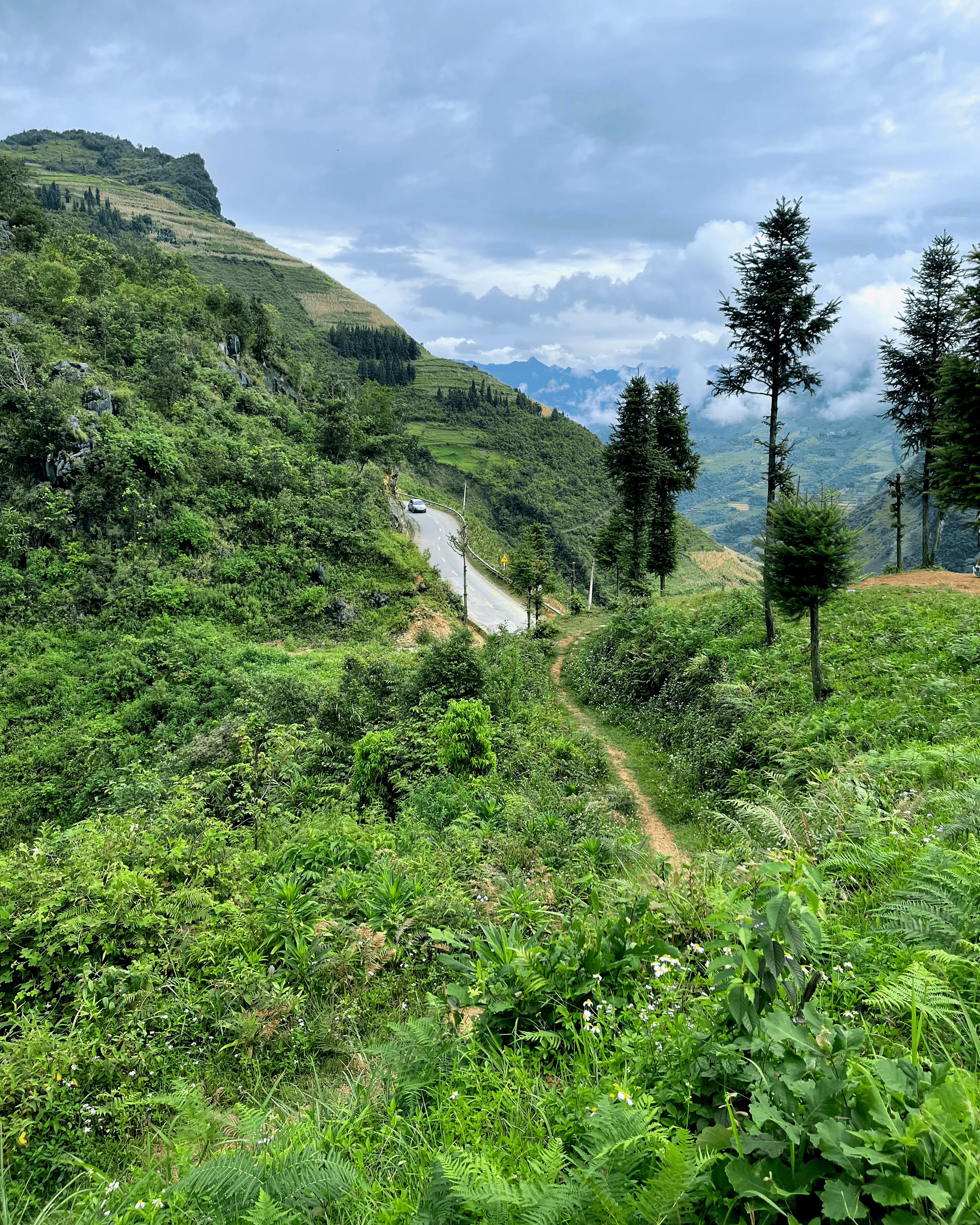 Car driving on a mountain road in Ha Giang, Vietnam