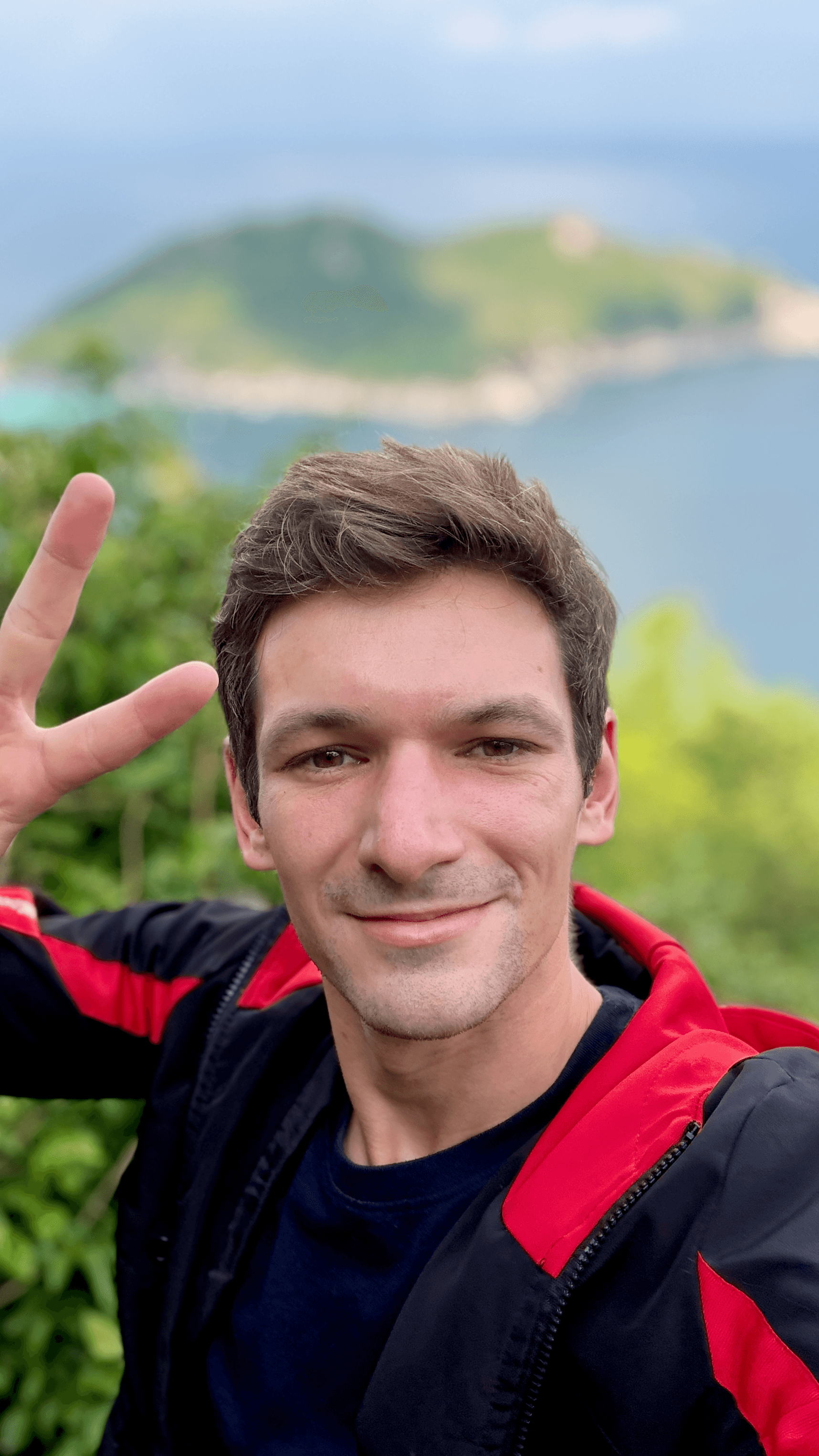 Matthew Fisher posing with peace sign at Grandfather Rock on Koh Tao, Thailand