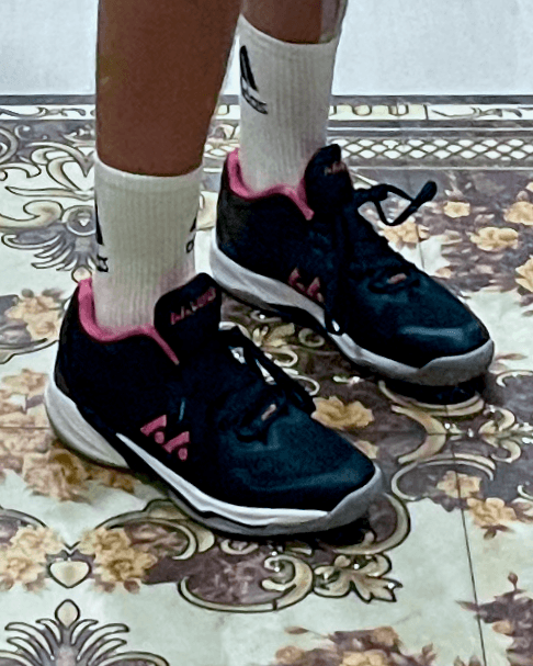 Black and pink shoes on a tiled floor